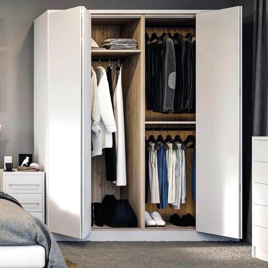 Bi-fold door wardrobe with clothes in a room.