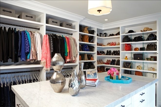 Walk in Closet with island and designated place on the shelves for accessories