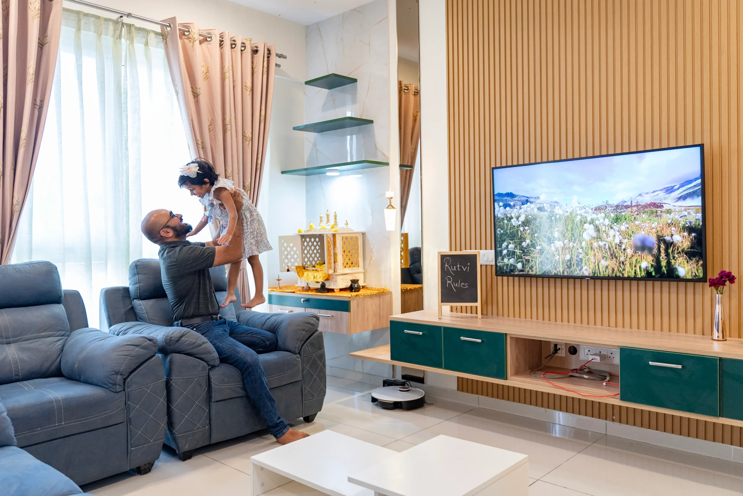 Happy family in living room designed by the best interior designer in Electronic City