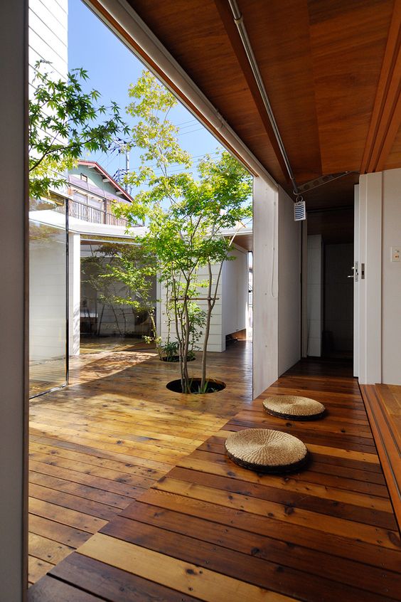 Open Ceiling Courtyard House Design with Wooden Flooring 