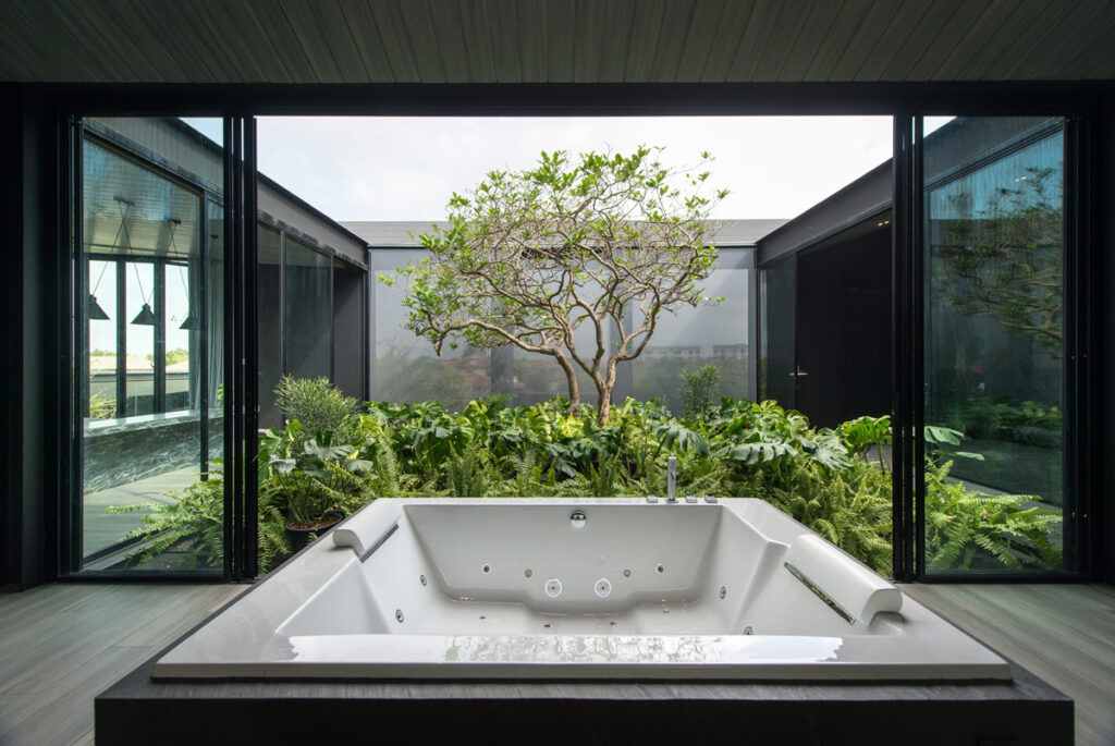 Jacuzzi Opening to a Lush Green Courtyard Design